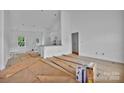 Bright, white interior featuring an open floor plan connecting the living room, dining area, and kitchen at 6155 Long Branch Rd, Salisbury, NC 28147