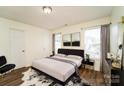 Main bedroom with plush carpeting and a large window at 2327 Hope Valley Ln, Charlotte, NC 28213