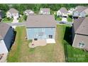 Aerial view of the home's backyard featuring a patio and fire pit at 3023 Spinner Ct, Denver, NC 28037