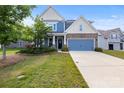 Well-maintained two-story home with stone accents, a two-car garage, and beautiful landscaping at 3023 Spinner Ct, Denver, NC 28037