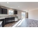 Modern kitchen with dark cabinetry, granite counters, and stainless steel appliances at 7741 Marlette Ln, Sherrills Ford, NC 28673
