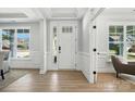 Bright and welcoming foyer with elegant white trim, hardwood floors, and views of the front yard at 2016 Cedar Falls Dr # 7, Waxhaw, NC 28173