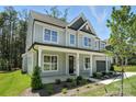 Beautiful two-story home with a covered front porch and well-maintained landscaping, surrounded by lush trees at 2016 Cedar Falls Dr # 7, Waxhaw, NC 28173