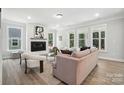 Bright living room features a cozy fireplace, large windows, and stylish furnishings at 2016 Cedar Falls Dr # 7, Waxhaw, NC 28173