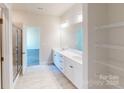 Double vanity bathroom with a walk-in shower and linen shelving at 503 Tates Trl # 8, Cramerton, NC 28032