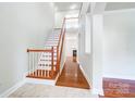 Bright entryway with wood floors and staircase at 14447 Waterlyn Dr, Charlotte, NC 28278