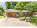 Front view of brick ranch house with light blue shutters and a covered porch at 621 Oak Grove Rd, Kings Mountain, NC 28086