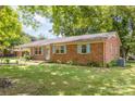 Side view of brick ranch house with light blue shutters and landscaping at 621 Oak Grove Rd, Kings Mountain, NC 28086