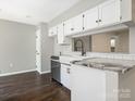 Updated kitchen featuring white cabinets, stainless steel appliances, granite countertops, and modern fixtures at 7378 Winery Ln, Charlotte, NC 28227