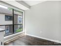 Bright and modern room with dark wood floors and a large window overlooking the neighborhood at 7378 Winery Ln, Charlotte, NC 28227