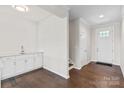 Entryway with a wet bar with white cabinets and hardwood floors at 4679 Hopsack Dr # Cal0108, Indian Trail, NC 28079
