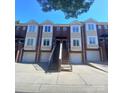 Brick townhome with white trim, attached garages, and shared staircase leading to front doors at 1125 Kurt Ct, Charlotte, NC 28209
