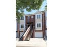 Brick townhome with white trim, attached garages, and shared staircase leading to front doors at 1125 Kurt Ct, Charlotte, NC 28209