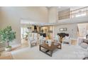 Open-concept living room with a high ceiling and a view of the kitchen at 4023 Randolph Rd, Charlotte, NC 28211