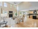 Open concept living room with fireplace flowing into the kitchen and dining area at 4023 Randolph Rd, Charlotte, NC 28211