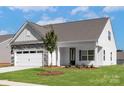 Beautiful single-story home displaying stone details, a two-car garage, and a well-maintained lawn at 126 Brixham Loop, Troutman, NC 28166