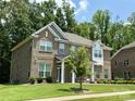 A beautiful two-story brick home with well-maintained landscaping and a lush, green lawn in a suburban setting at 2044 Sweet William Dr, Harrisburg, NC 28075