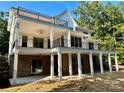 Back exterior of home with an outdoor living space that boasts multiple decks and covered patio area at 416 Plantation Way, Mount Gilead, NC 27306