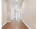 Bright hallway with wood flooring leads to living spaces, showcasing the home's layout at 831 B Wynnshire Dr # 60, Hickory, NC 28601