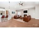 Open-concept living room with a fireplace, hardwood floors and bar seating at the kitchen counter at 831 B Wynnshire Dr # 60, Hickory, NC 28601