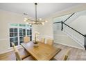 Dining room boasts a modern chandelier, large windows and leads into a staircase at 2907 Meherrin Ct, Waxhaw, NC 28173