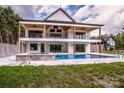 A two-story home with a spacious patio, swimming pool, and lush greenery at 110 Emmaline Ct, Troutman, NC 28166