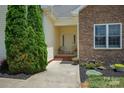 Inviting front porch with a cozy seating area, stone accents, and well-maintained landscaping at 104 Castle Pines Ln, Statesville, NC 28625