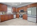 Well-equipped kitchen featuring granite countertops, updated appliances and ample wooden cabinetry at 104 Castle Pines Ln, Statesville, NC 28625