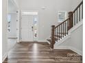 Two-story entryway with hardwood floors and an elegant staircase at 108 Brooke Forest Ct, Mooresville, NC 28115