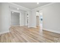 Spacious living room shows an open layout with hardwood floors, multiple entryways, and neutral paint, offering versatility at 232 E Warfield Dr, Mooresville, NC 28115