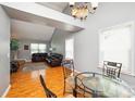 Open concept dining area with hardwood floors and a view of the living room at 4816 Windchase Ln, Charlotte, NC 28269