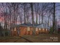 Charming brick home with a well-maintained lawn and mature trees providing shade and curb appeal at 3210 Marlborough Rd, Charlotte, NC 28208