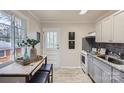 Efficient kitchen with stainless appliances, modern backsplash, and an adjacent dining area at 3210 Marlborough Rd, Charlotte, NC 28208