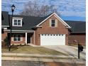 Two-car garage and front yard of brick home at 118 Abbington Ln, Shelby, NC 28150