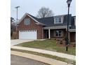 Brick ranch home with attached garage and landscaped lawn at 120 Abbington Ln, Shelby, NC 28150