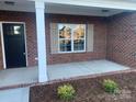 Covered front porch with brick columns and flooring at 120 Abbington Ln, Shelby, NC 28150