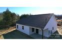 Rear view of house showcasing the dark roof and back porch at - Beltline Rd # 10, Chester, SC 29706