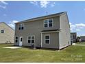 The back exterior features neutral siding, multiple windows, and a well-maintained lawn at 1009 Dawn Light Rd, Indian Trail, NC 28079