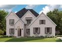 Charming brick home featuring symmetrical design, shuttered windows, and inviting curb appeal at 127 Palos Verde Rd, Mooresville, NC 28117