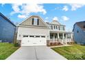 Two-story home with a two-car garage, attractive siding and stone accents, and a welcoming front porch at 1770 Post Ct # Lot 510, Gastonia, NC 28054