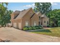 Two-story home with a three-car garage and manicured landscaping at 122 Long Cove Ln, Mooresville, NC 28117