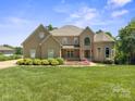 Beautiful home featuring a well-manicured lawn and tasteful landscaping at 122 Long Cove Ln, Mooresville, NC 28117