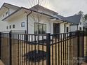 Private backyard with a black metal fence and young trees at 13217 Terrace Court Dr, Charlotte, NC 28278