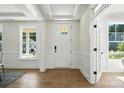 Bright entryway features wood floors, white trim, and a stylish front door with glass accents at 2027 Cedar Falls Dr # 75, Waxhaw, NC 28173