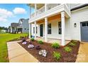 Inviting covered front porch with stained wood ceiling and view of beautiful landscaping at 2027 Cedar Falls Dr # 75, Waxhaw, NC 28173