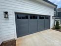 Gray garage door with windows above, complementing the home's exterior at 2027 Cedar Falls Dr # 75, Waxhaw, NC 28173
