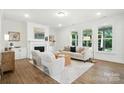 Sunlit living room boasts a fireplace, built-ins, and large windows offering a beautiful view at 2027 Cedar Falls Dr # 75, Waxhaw, NC 28173