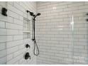 Modern bathroom shower with white subway tile and matte black shower fixtures at 2027 Cedar Falls Dr # 75, Waxhaw, NC 28173
