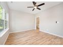 Bright bedroom with a ceiling fan, light-colored walls, and wood-look flooring at 1011 Indiana St, Kannapolis, NC 28083