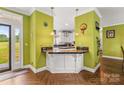 Kitchen bar area with breakfast bar seating and herringbone hardwood flooring at 3951 Springs Rd, Conover, NC 28613